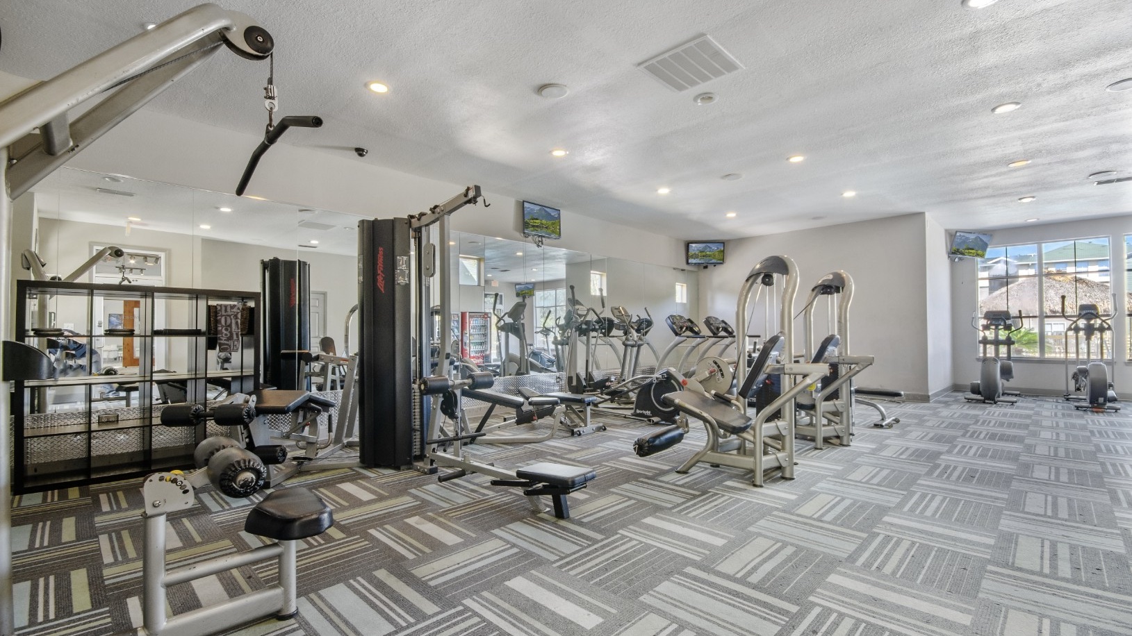 Fitness center with cardio and strength training equipment at The Asher