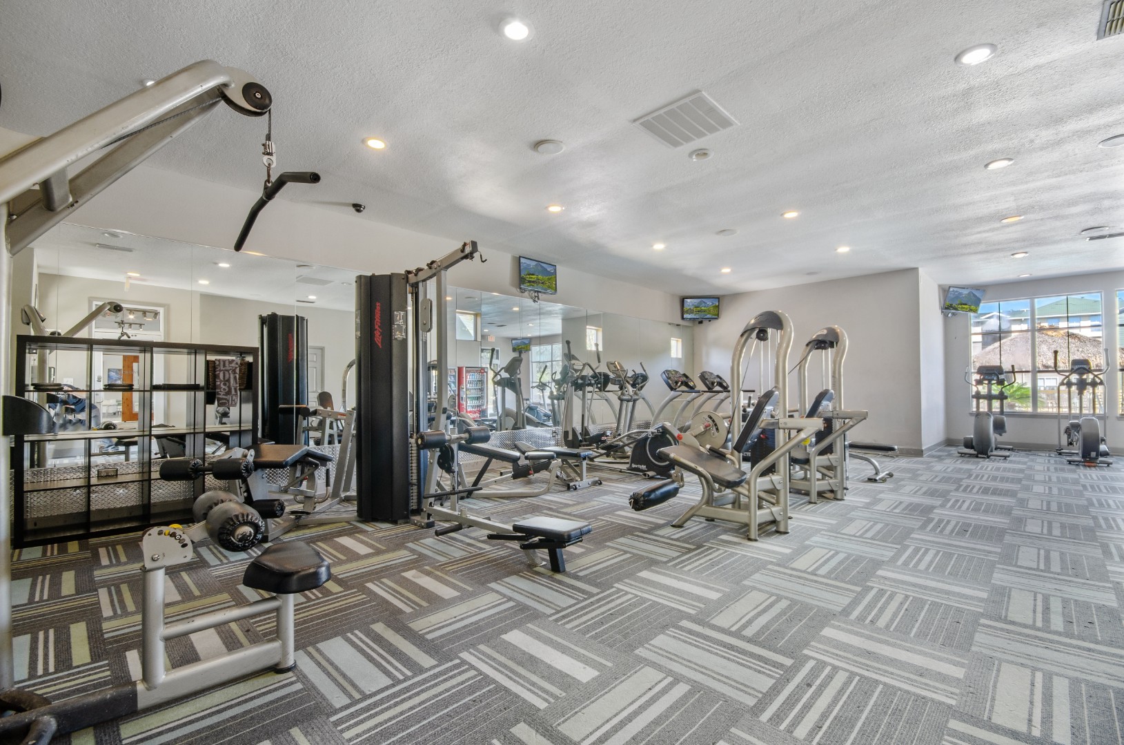 Fitness center with cardio and strength training equipment at The Asher